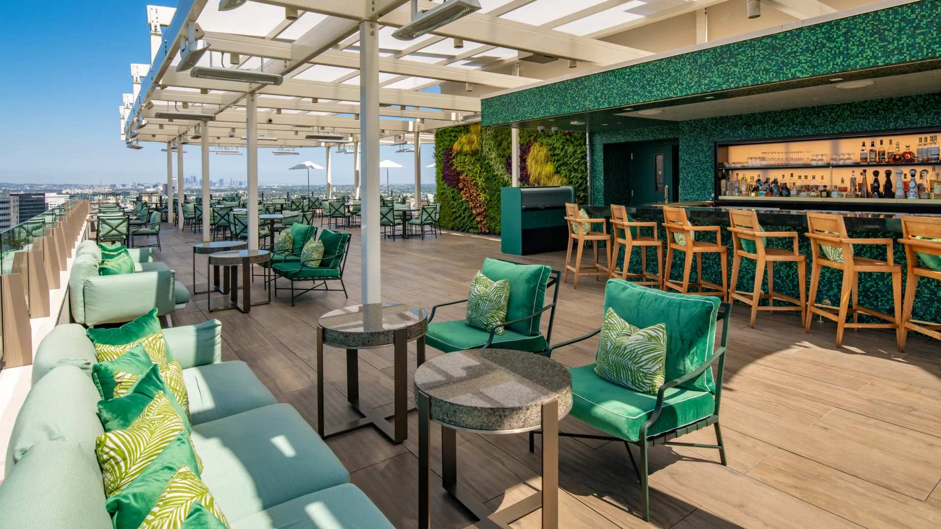Rooftop lounge and bar at The Peninsula Beverly Hills with panoramic city views.