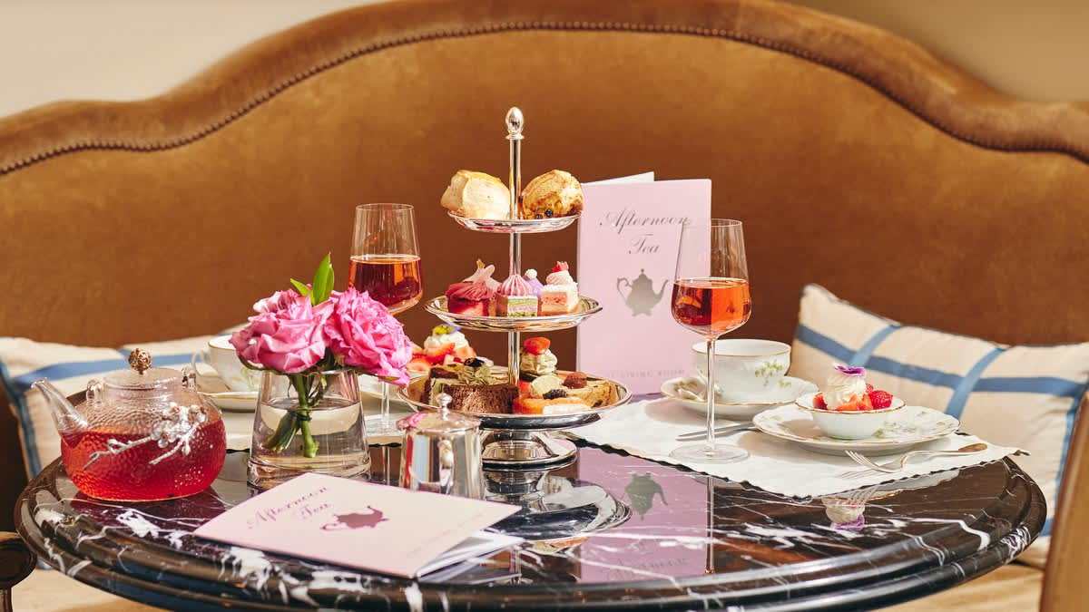 Elegant afternoon tea setup with pastries, tea, and wine at The Peninsula Beverly Hills.