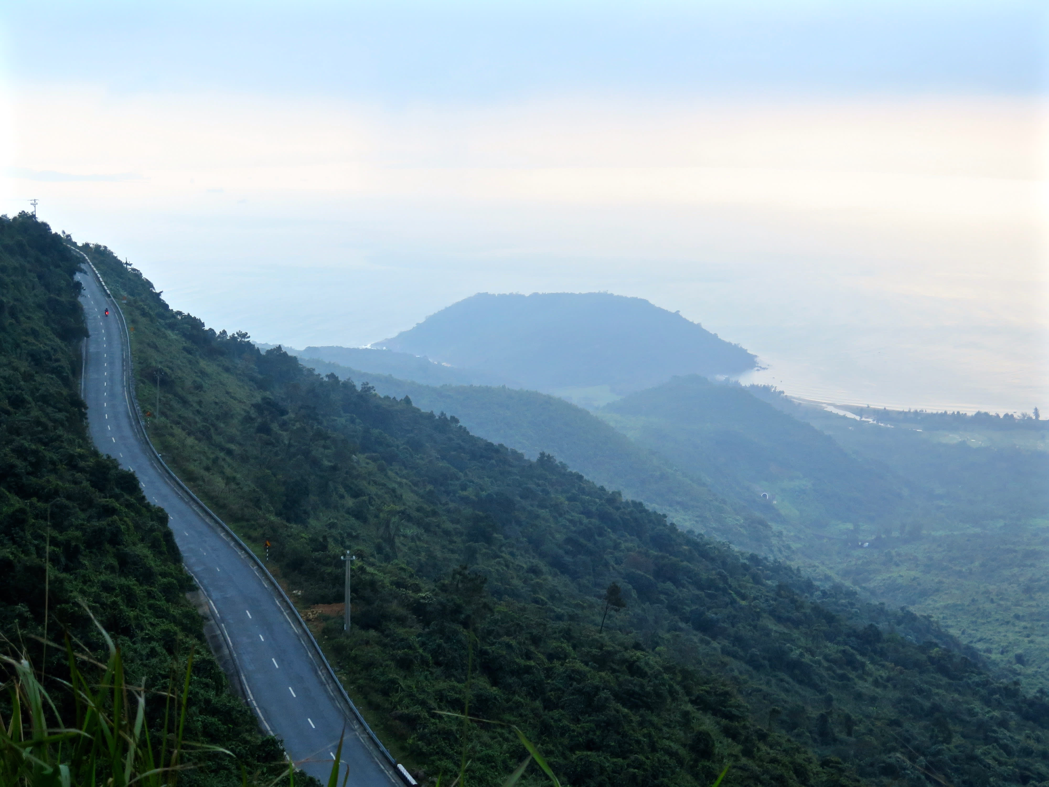 The Hai Van Pass through lush green mountains overlooking the ocean in Lang Co, Vietnam.