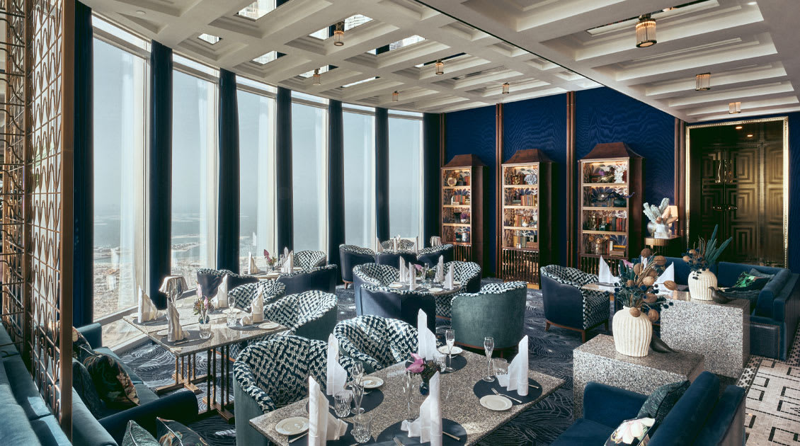 Luxurious dining area with elegant decor and large windows offering panoramic views of the city.