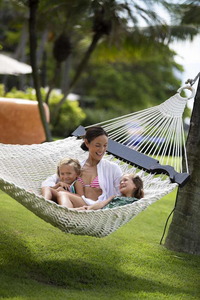 A member of the vacation club Exclusive Resorts relaxing in a hammock with her two children at a private home in Real del Mar, Mexico.