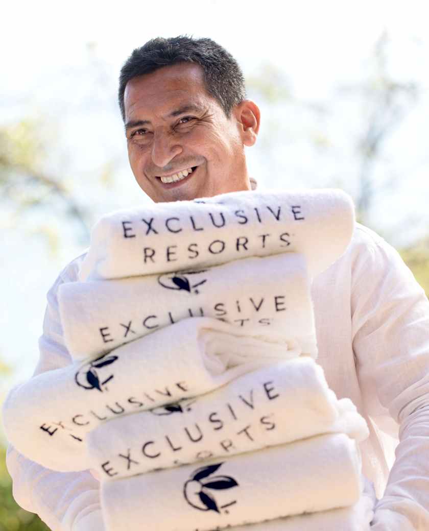 An on-site concierge at an Exclusive Resorts private home holding a ...