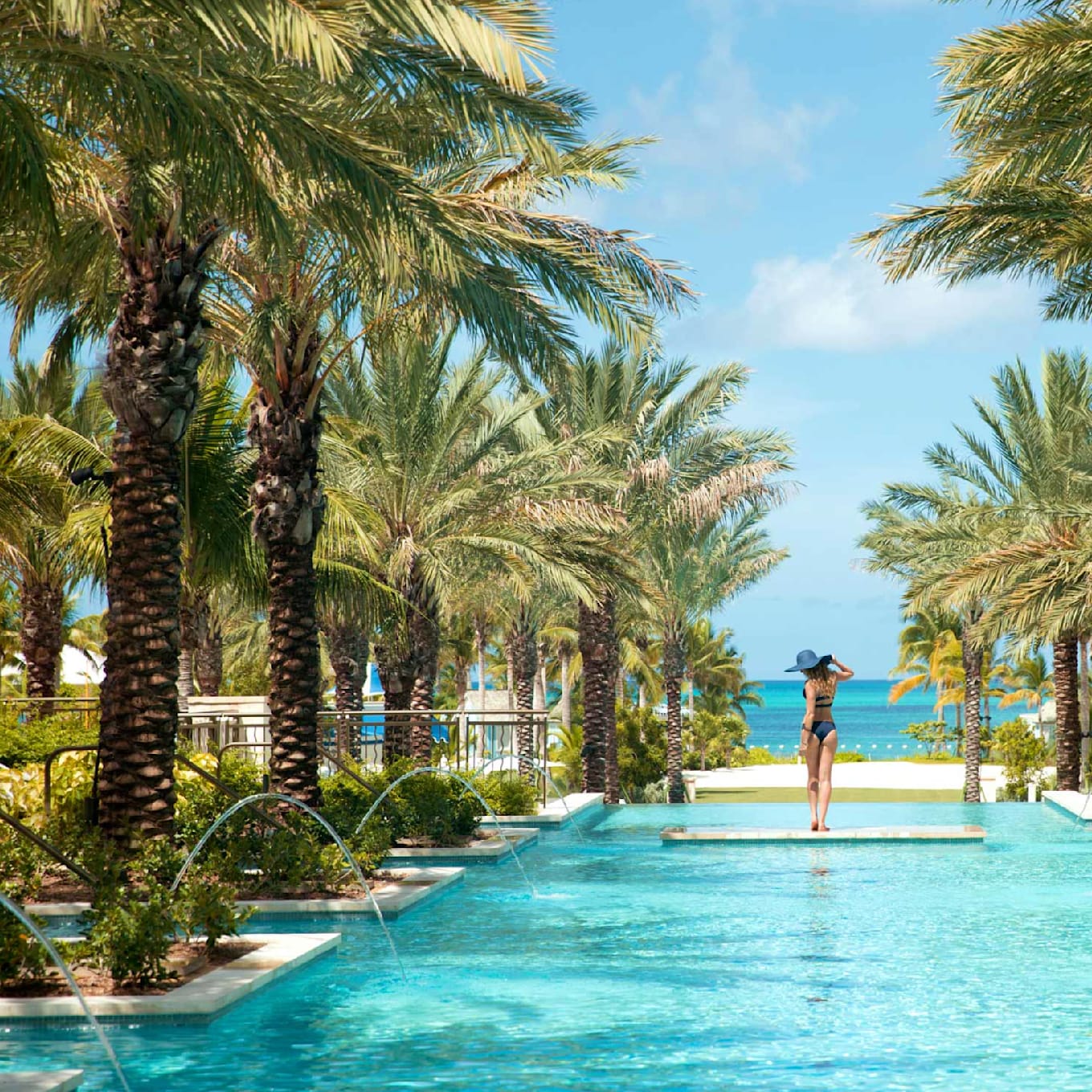 A woman posing in the middle of a resort pool in Baha Mar, Bahamas.